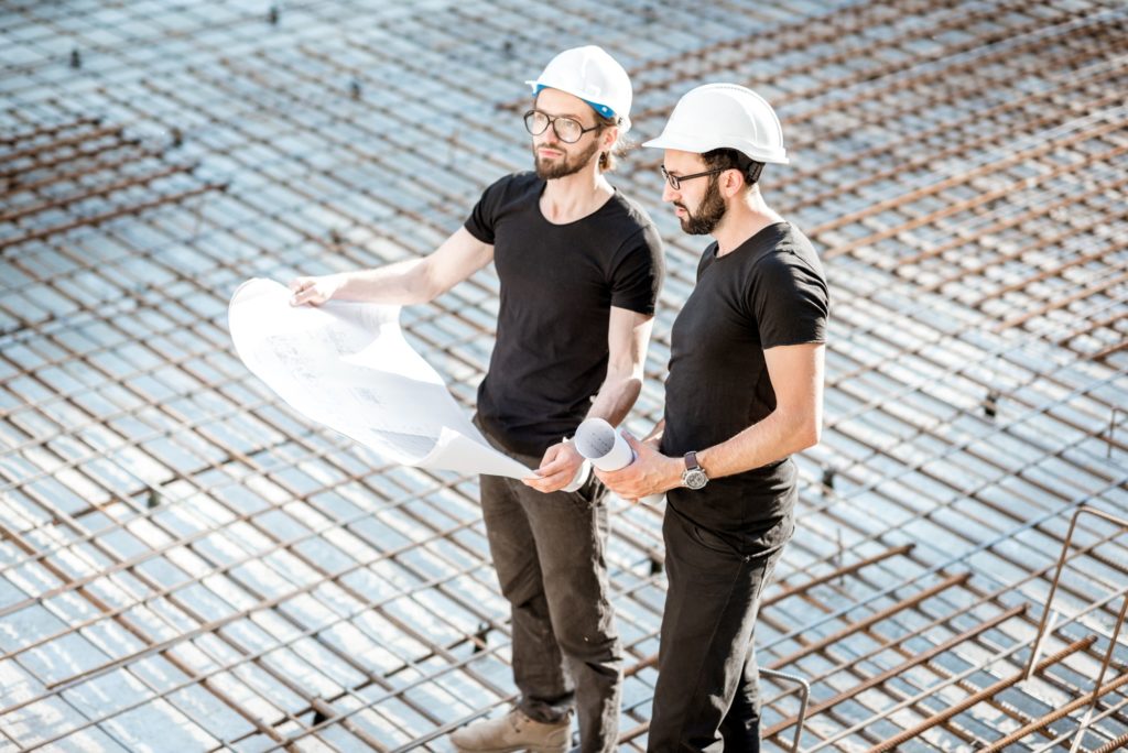 Builders with drawings at the construction site